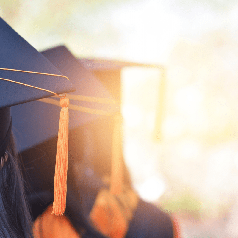 Three students wearing graduation caps