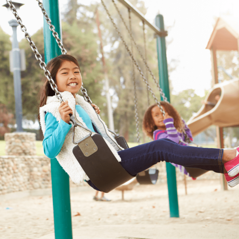 Children playing on swings