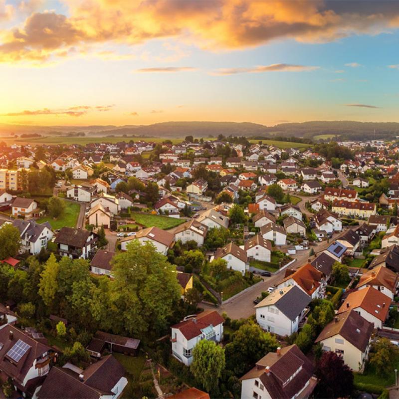 Aerial panorama of small town at sunrise