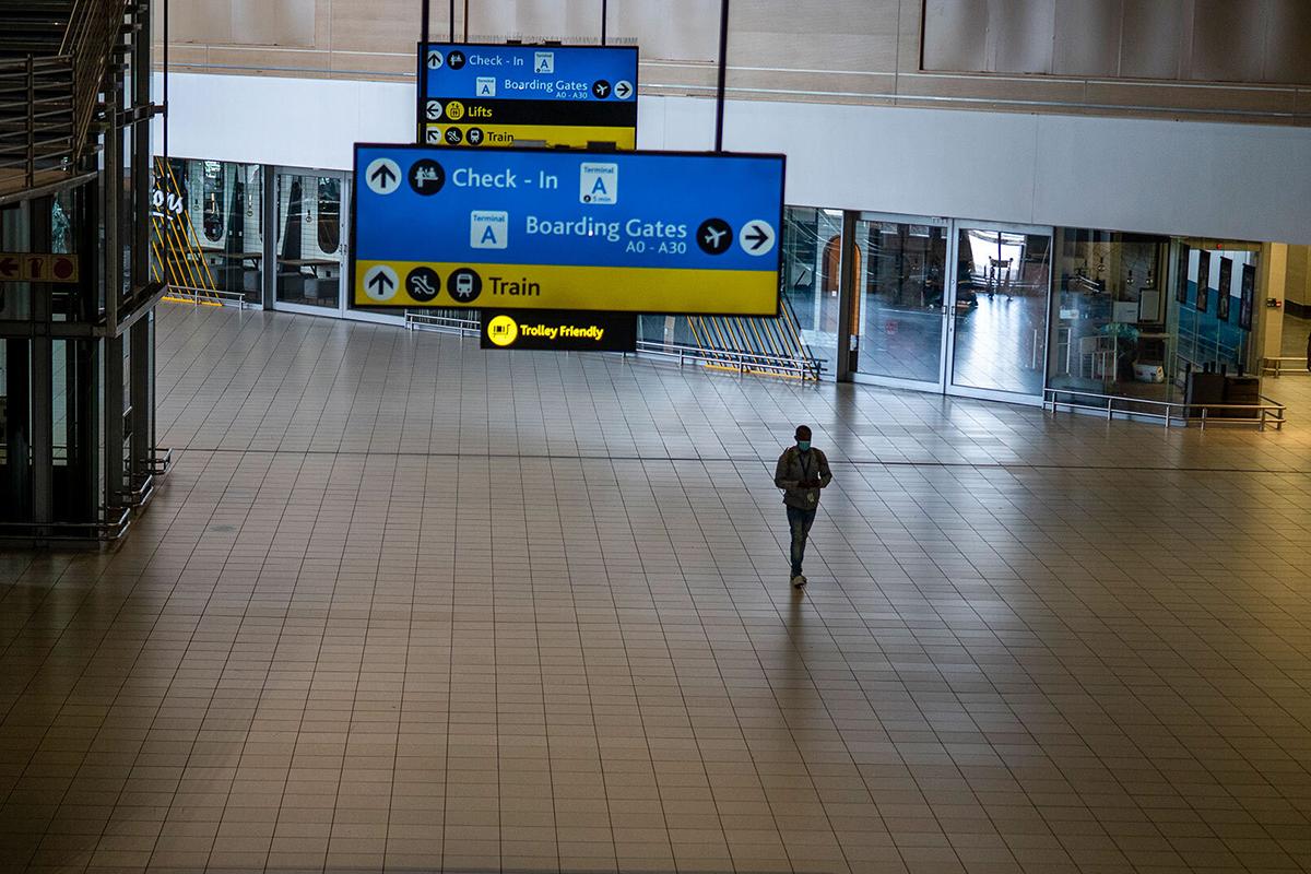 A man walks through a deserted airport terminal in Johannesburg, South Africa, on Monday after the United States and other nations imposed travel bans on the country, where the Omicron variant of COVID-19 was first detected. AP Photo/Jerome Delay