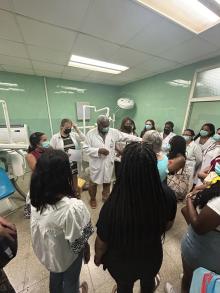 The students and a few nurses listened to the head doctor at the dentistry clinic.