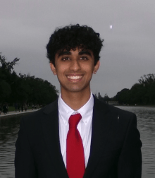 Man with black suit and red tie