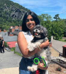 Girl with brown hair holding dog