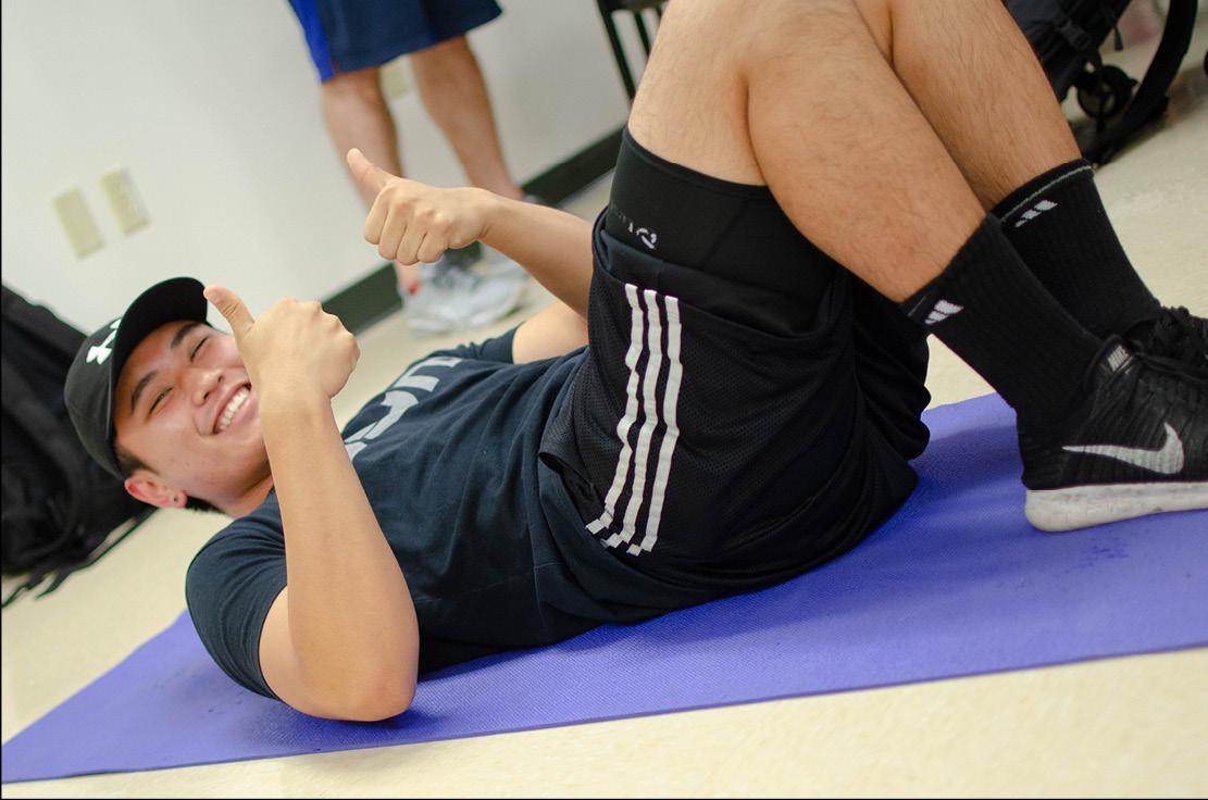 Student laying on a mat for a summer kinesiology course