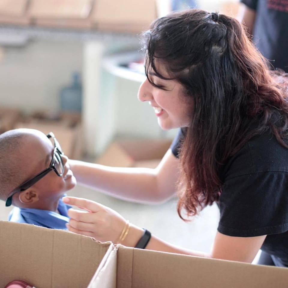 MPH student Pooja Doshi provides eye health care to a boy in Trinidad as part of a service trip.