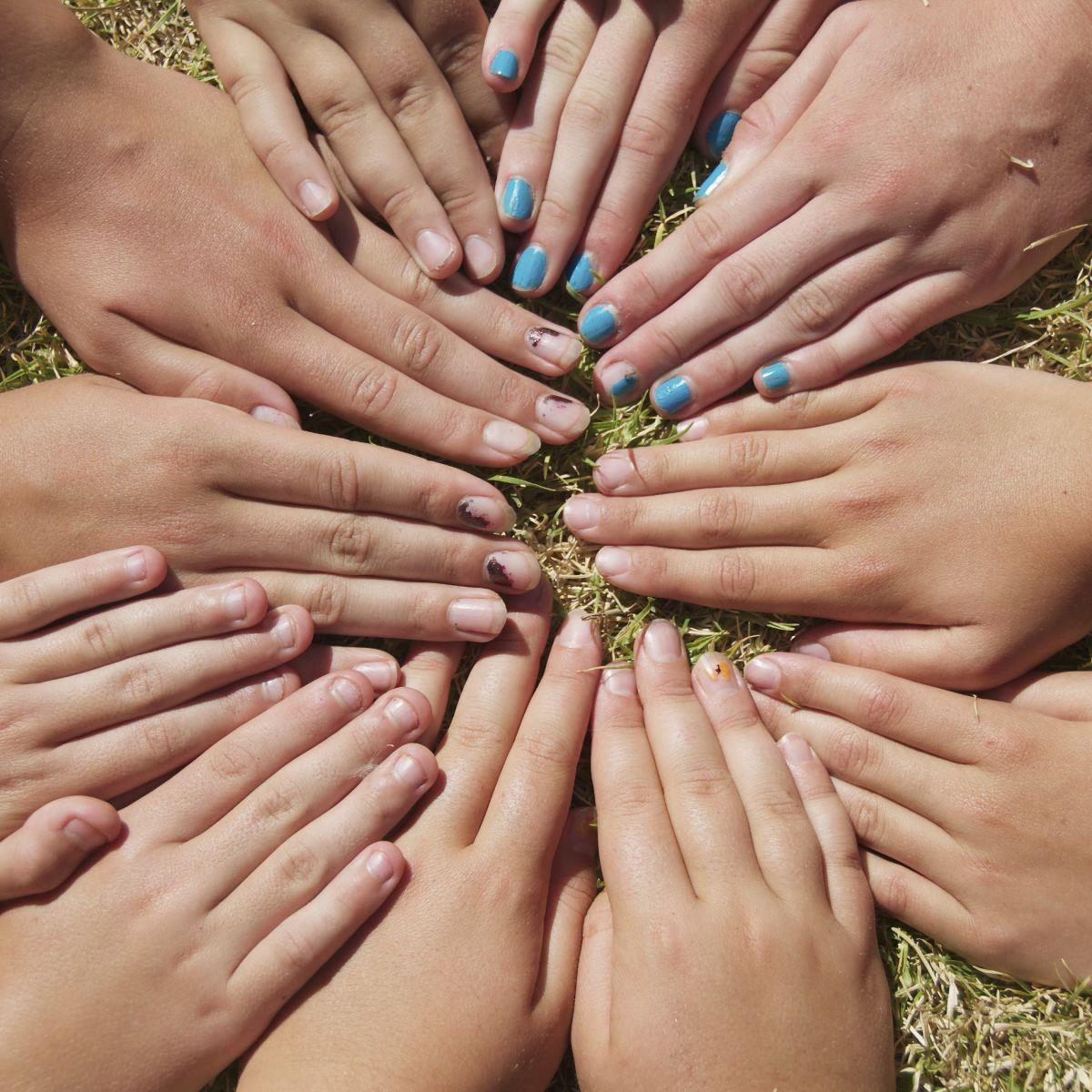 Hands in a circle on grass