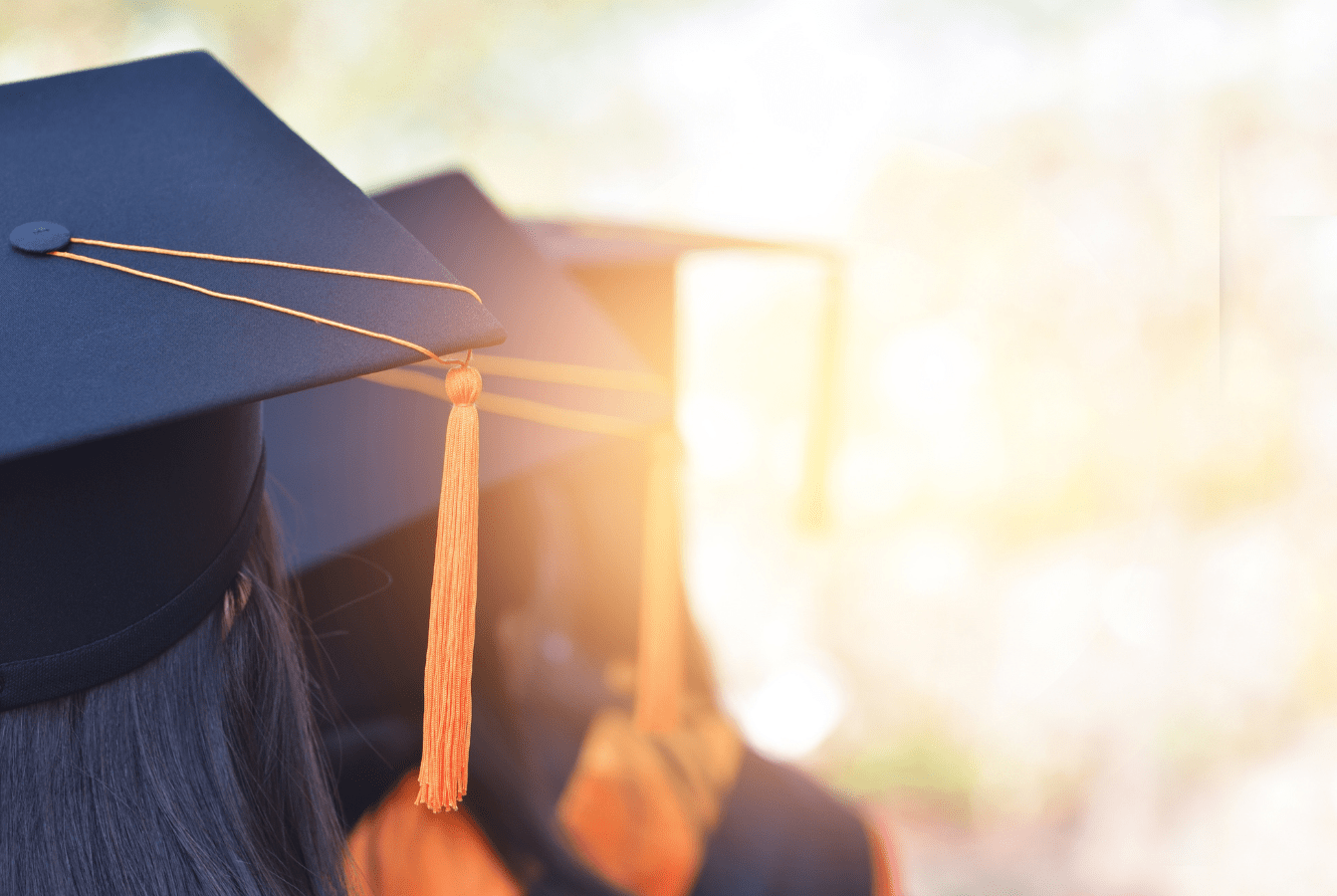 Three students wearing graduation caps