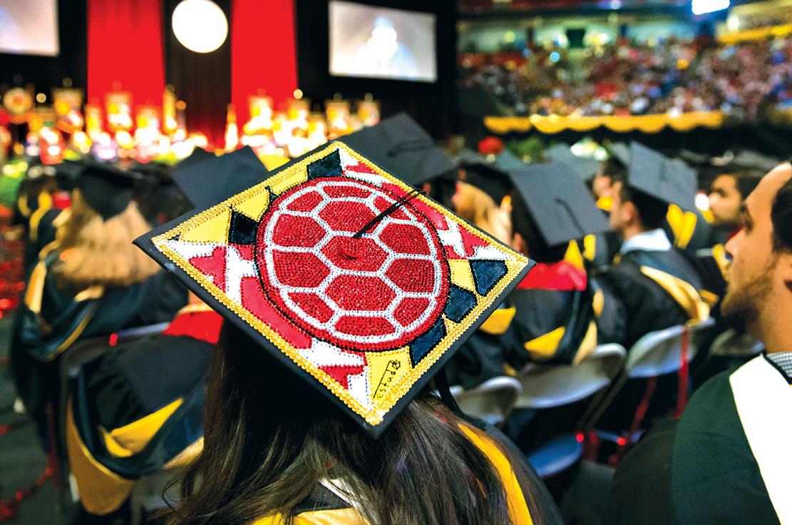 The University of Maryland Spring 2016 Commencement Ceremonies at the Xfinity Center, 18 May 2016. Shell logo on a graduation cap.