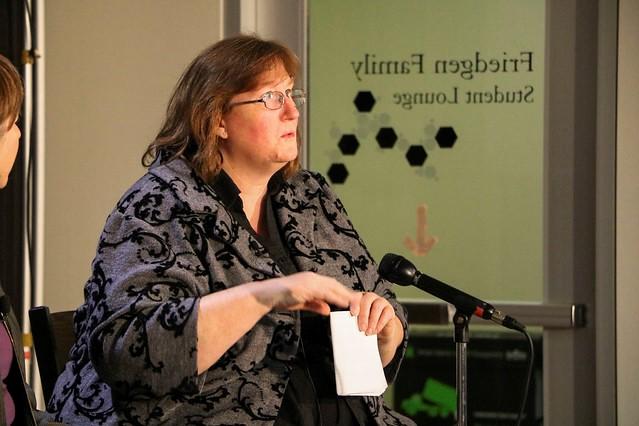 Christine Prue speaks at a microphone.