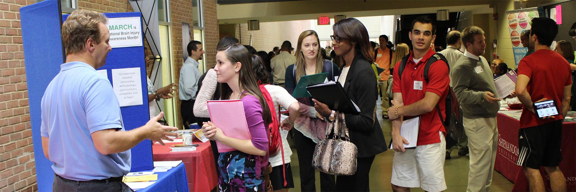 SPH Career Expo, student visiting various tables for career and academic opportunities and resources