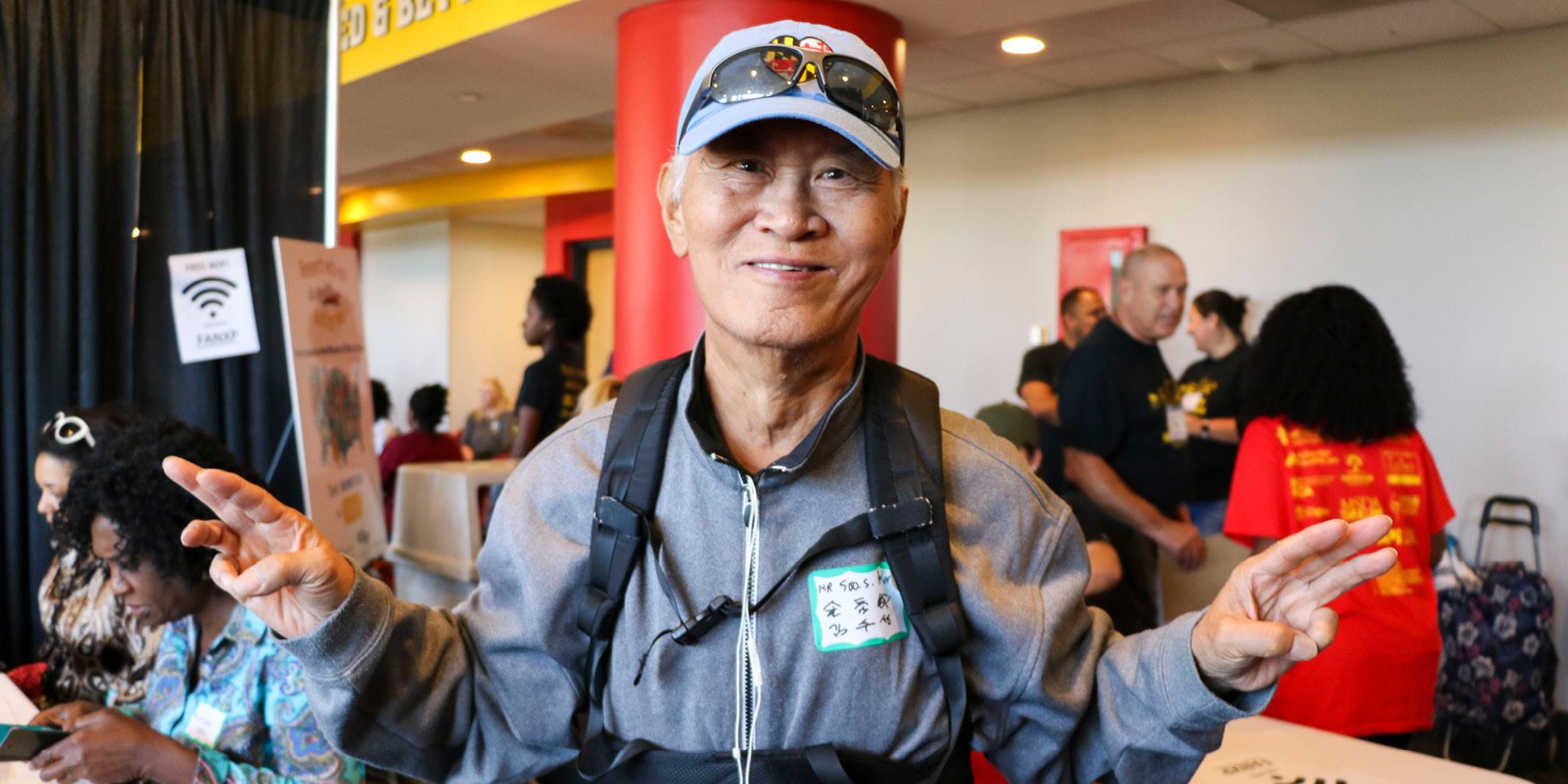 Man smiling at the camera with hands open at the Mid-Maryland Mission of Mercy and Health Equity Festival