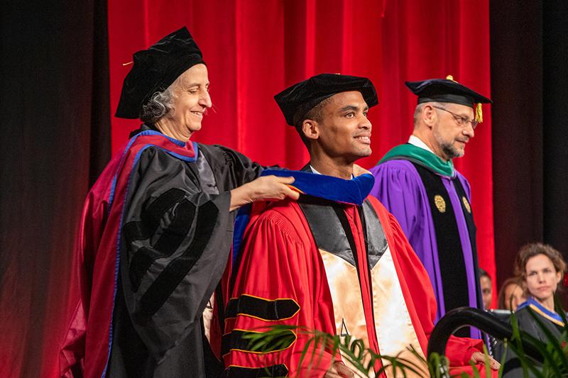 UMD SPH PhD student being hooded by department chair at commencement