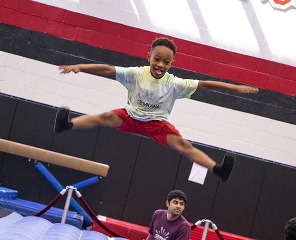 A kid jumping in a gym