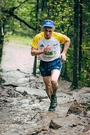 Master Athlete running up a cliff 