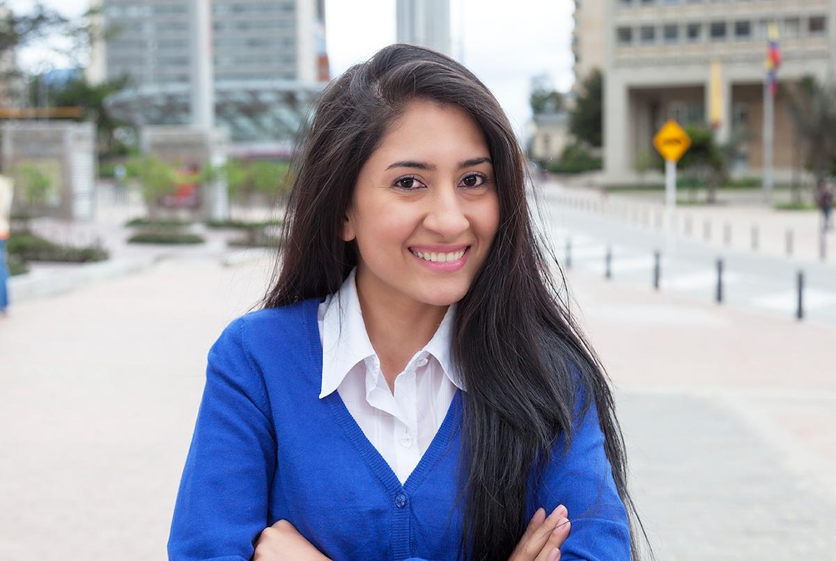 woman with dark straight hair smiles at camera