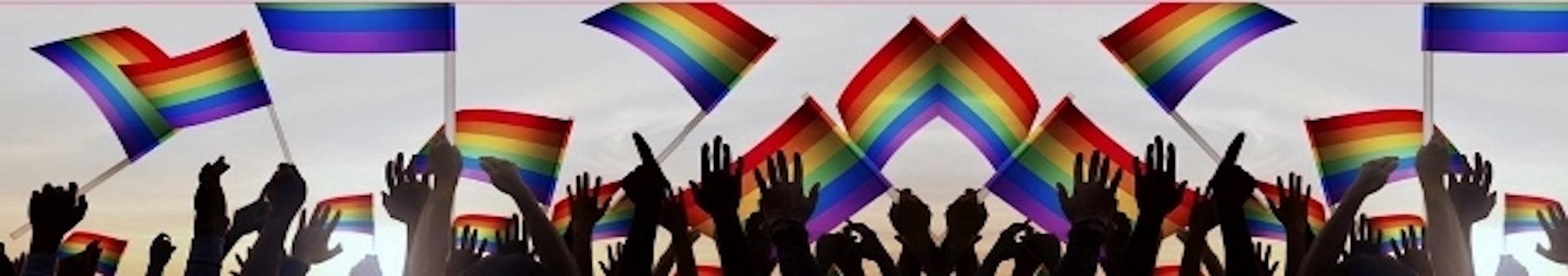 Hands waving Pride flags