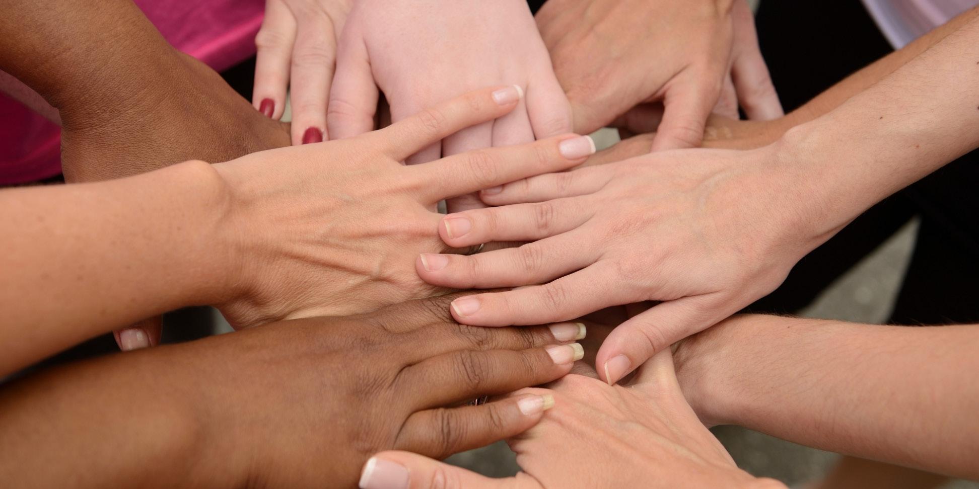 group of handed coming together at the center