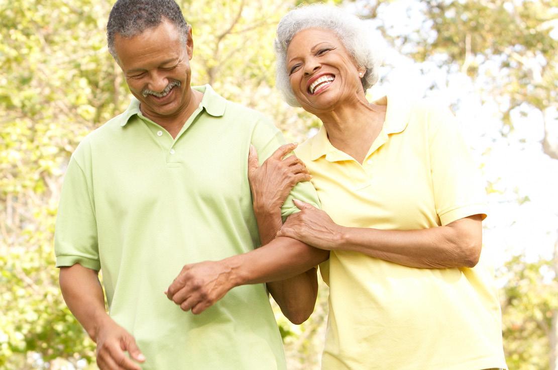 elderly couple smiling and walking together