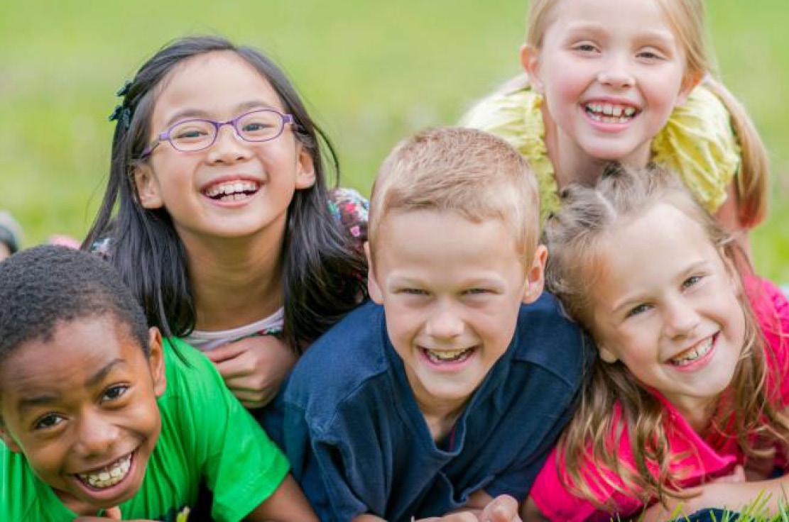 Children smiling in pyramid formation