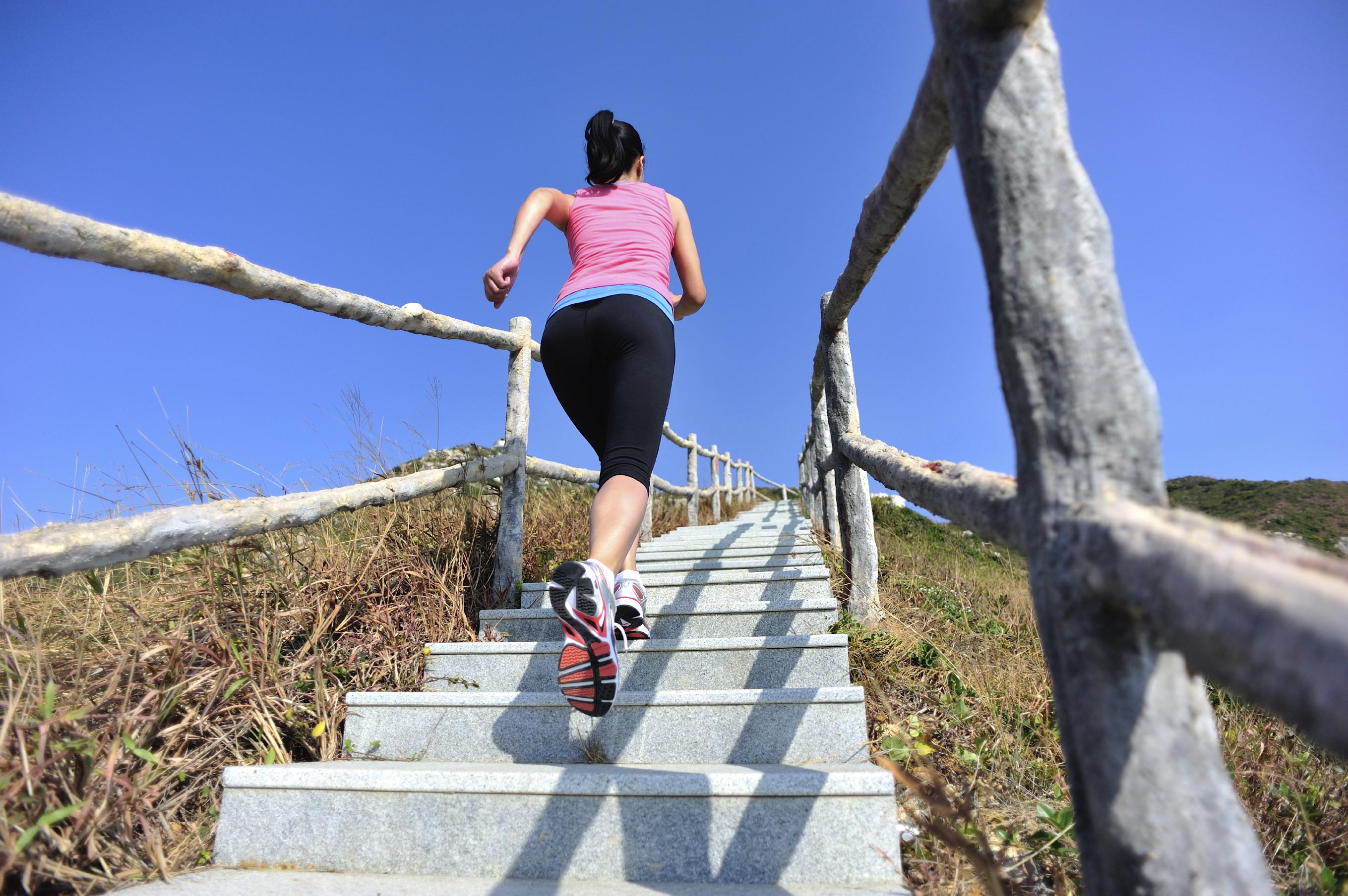 Woman running outside on set of stairs