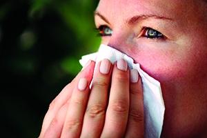 Person wiping their nose with a tissue