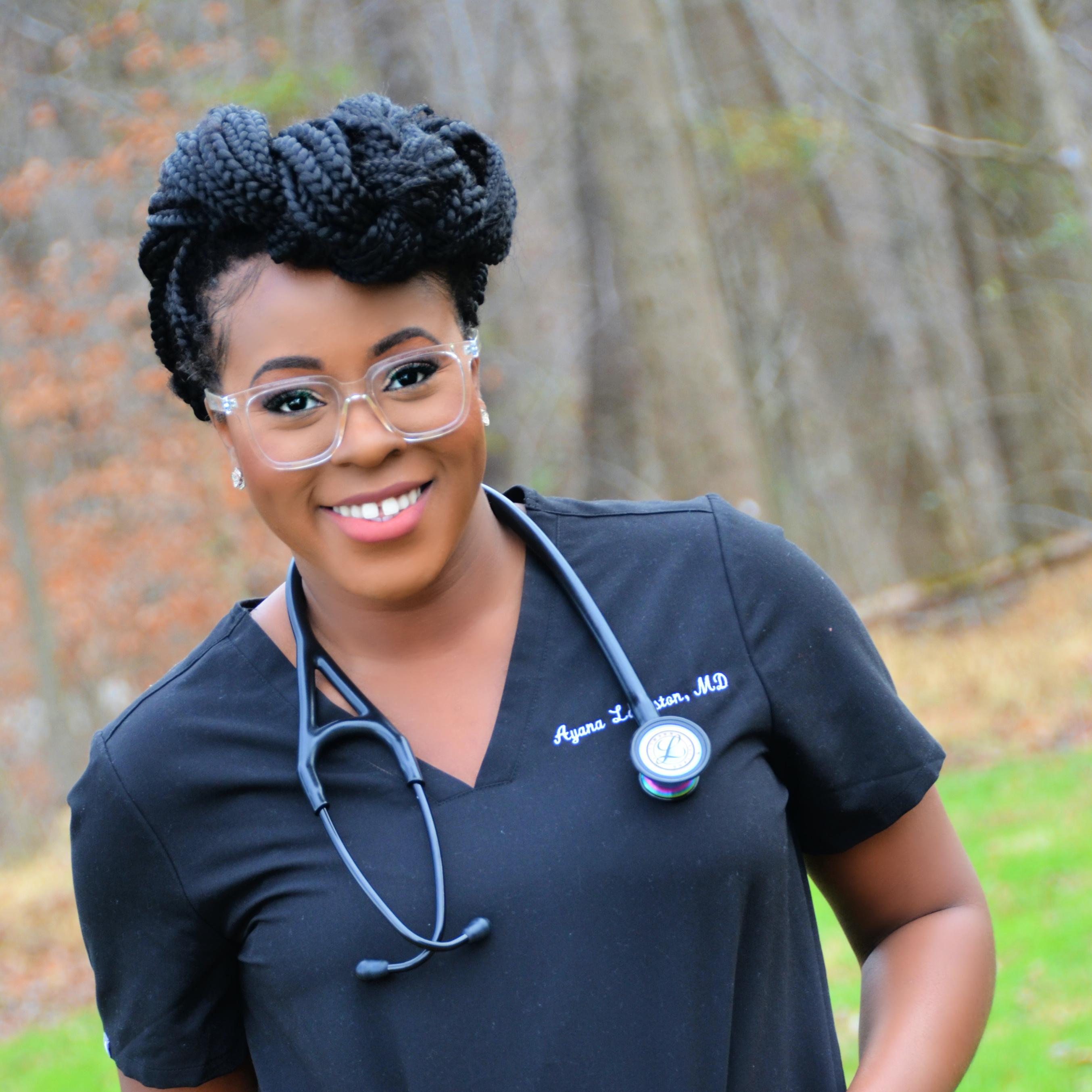Ayana Langston wearing glasses, a stethoscope around her neck and navy blue scrubs