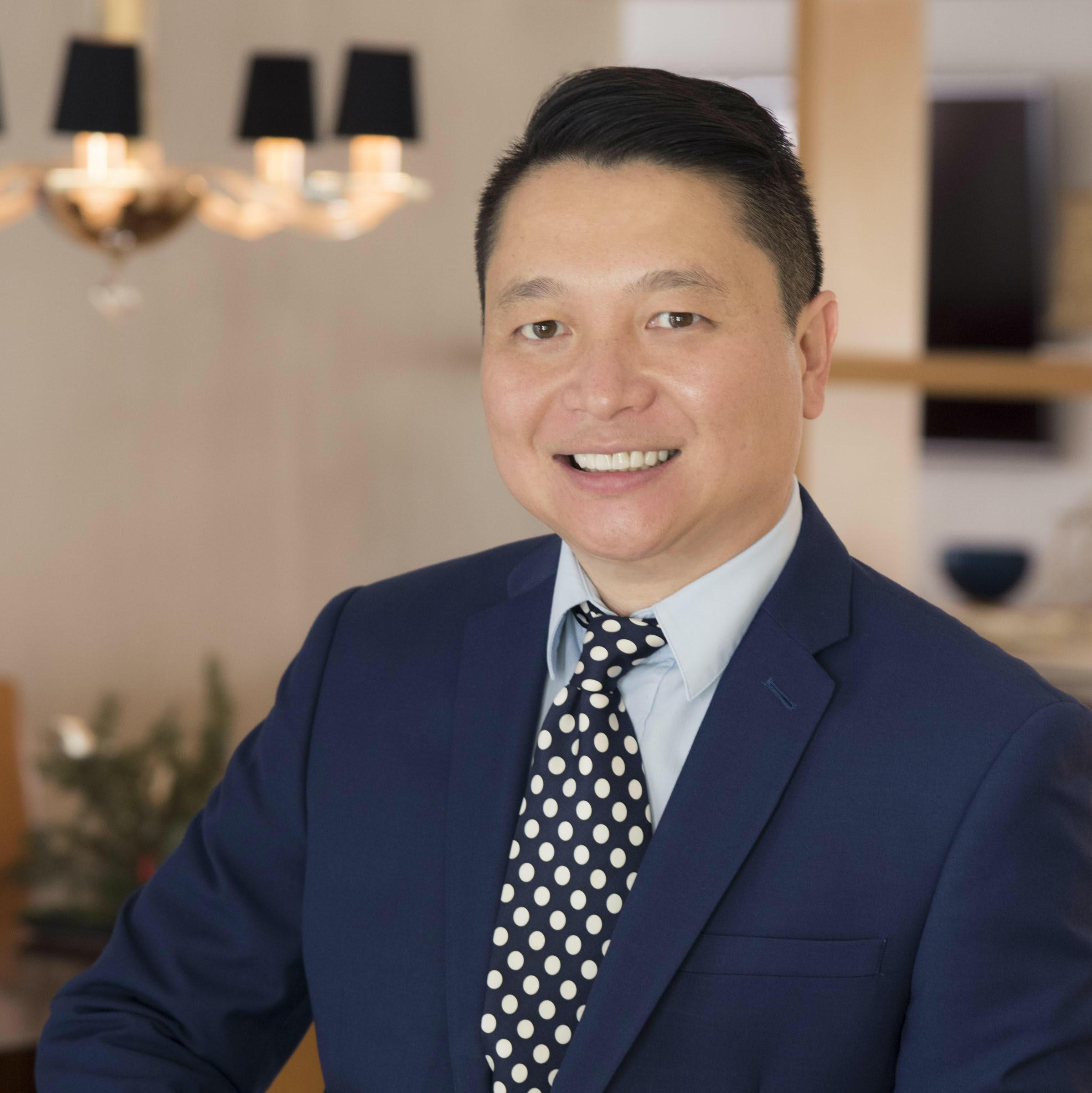 Mariano Kanamori wearing a navy blue suit, baby blue shirt and polka dotted tie