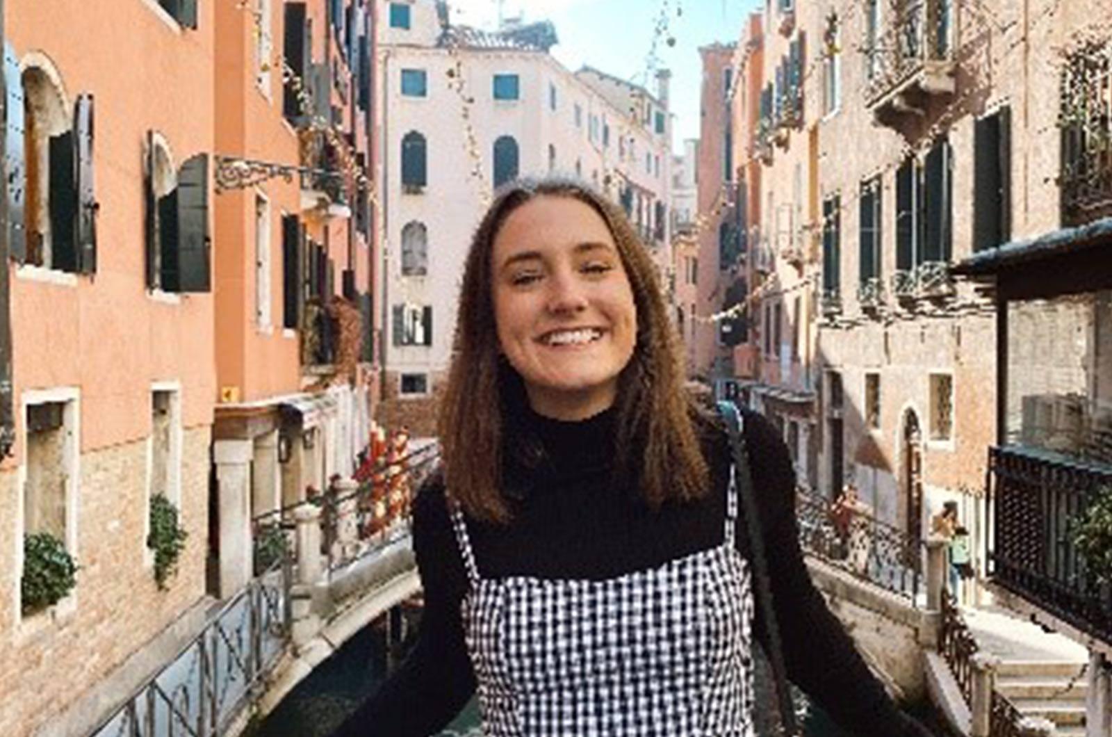 Student from the University of Maryland on bridge in Venice smiles at camera