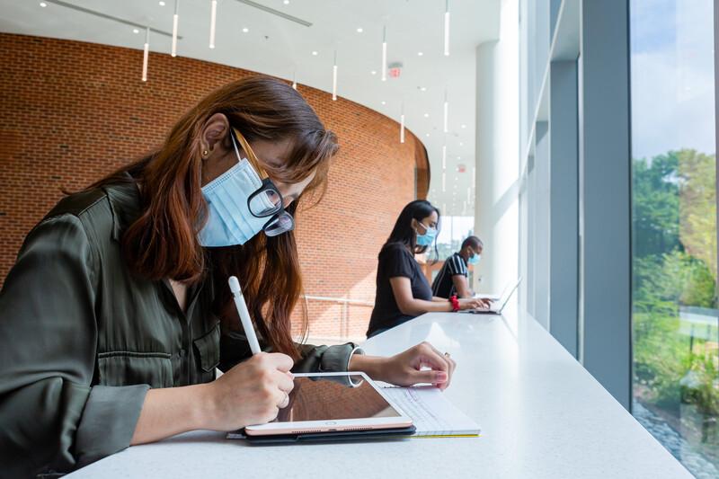 Student wearing mask inside building on campus