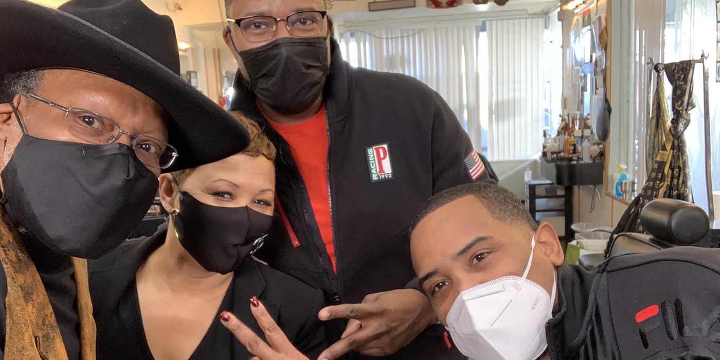 Professor Stephen B. Thomas with two barbers and a stylist who are part of the HAIR community health educators team.