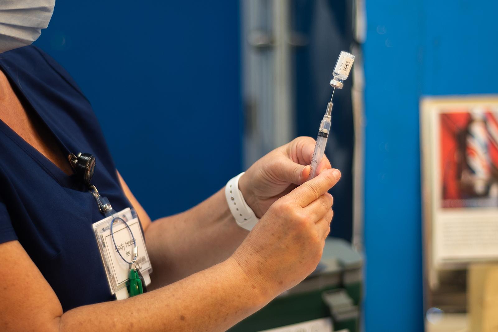 Close up of nurse preparing a COVID-19 shot