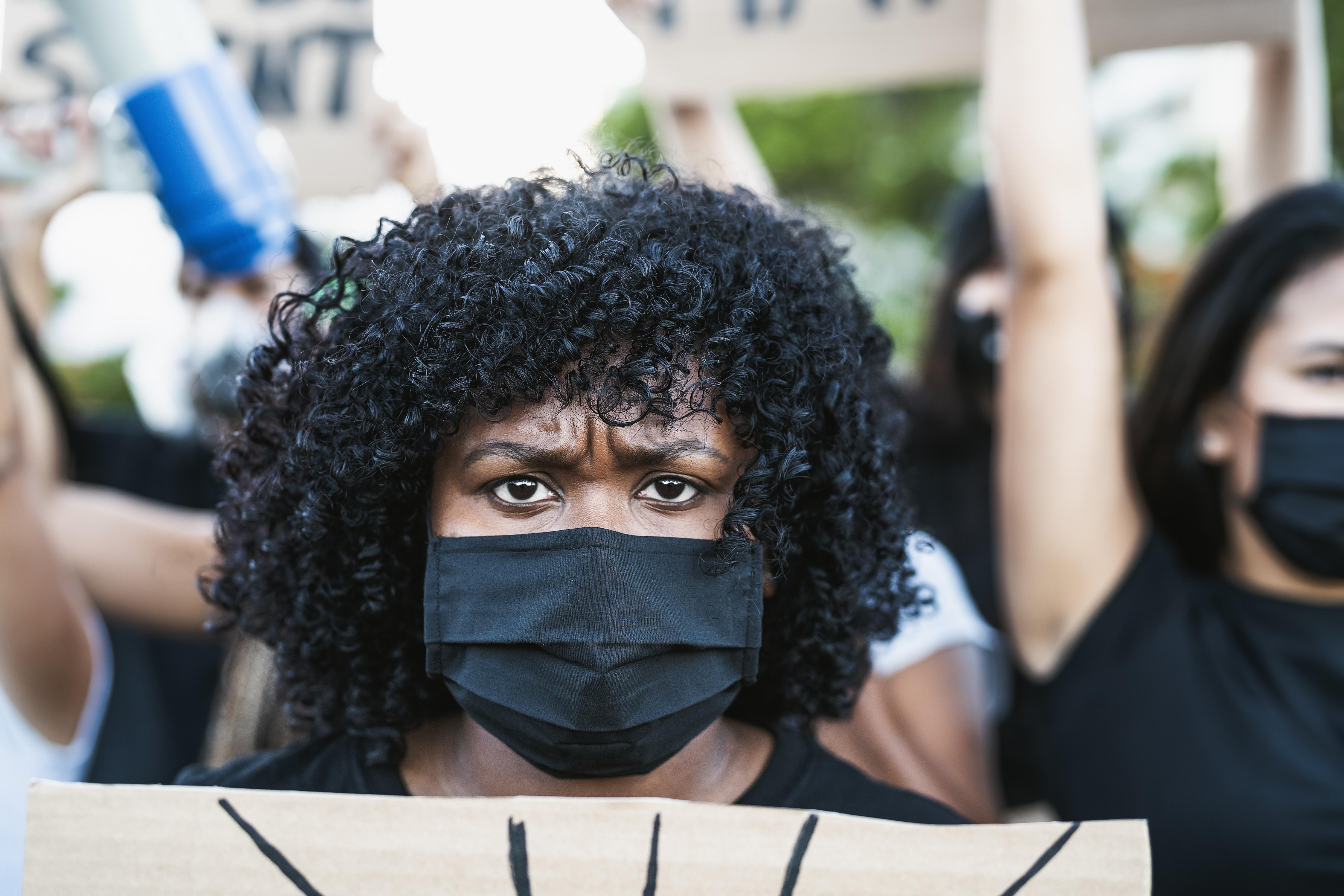 Black woman protesting in the streets