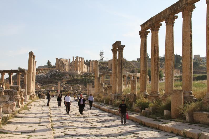 Picture of stone pathway and stone columns in Jordan with people walking