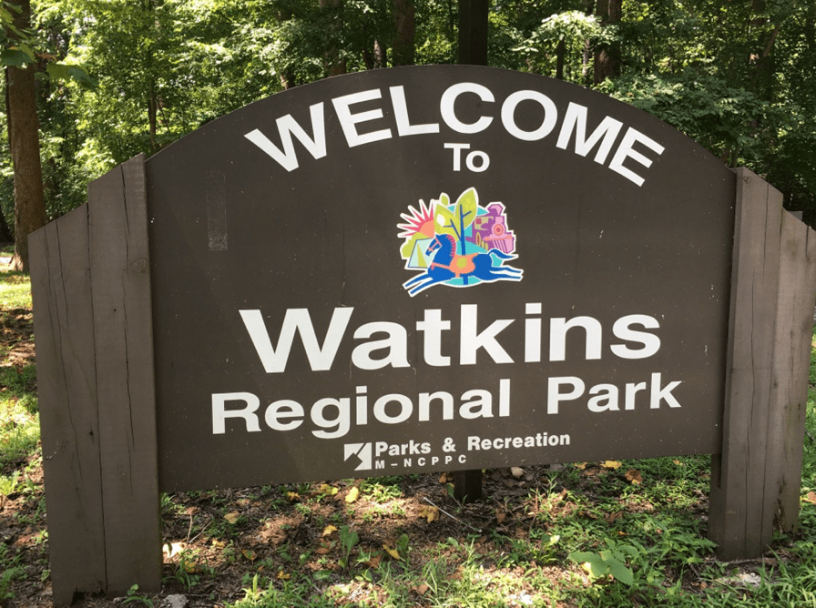 Wooden sign that reads "Welcome to Watkins Regional Park"