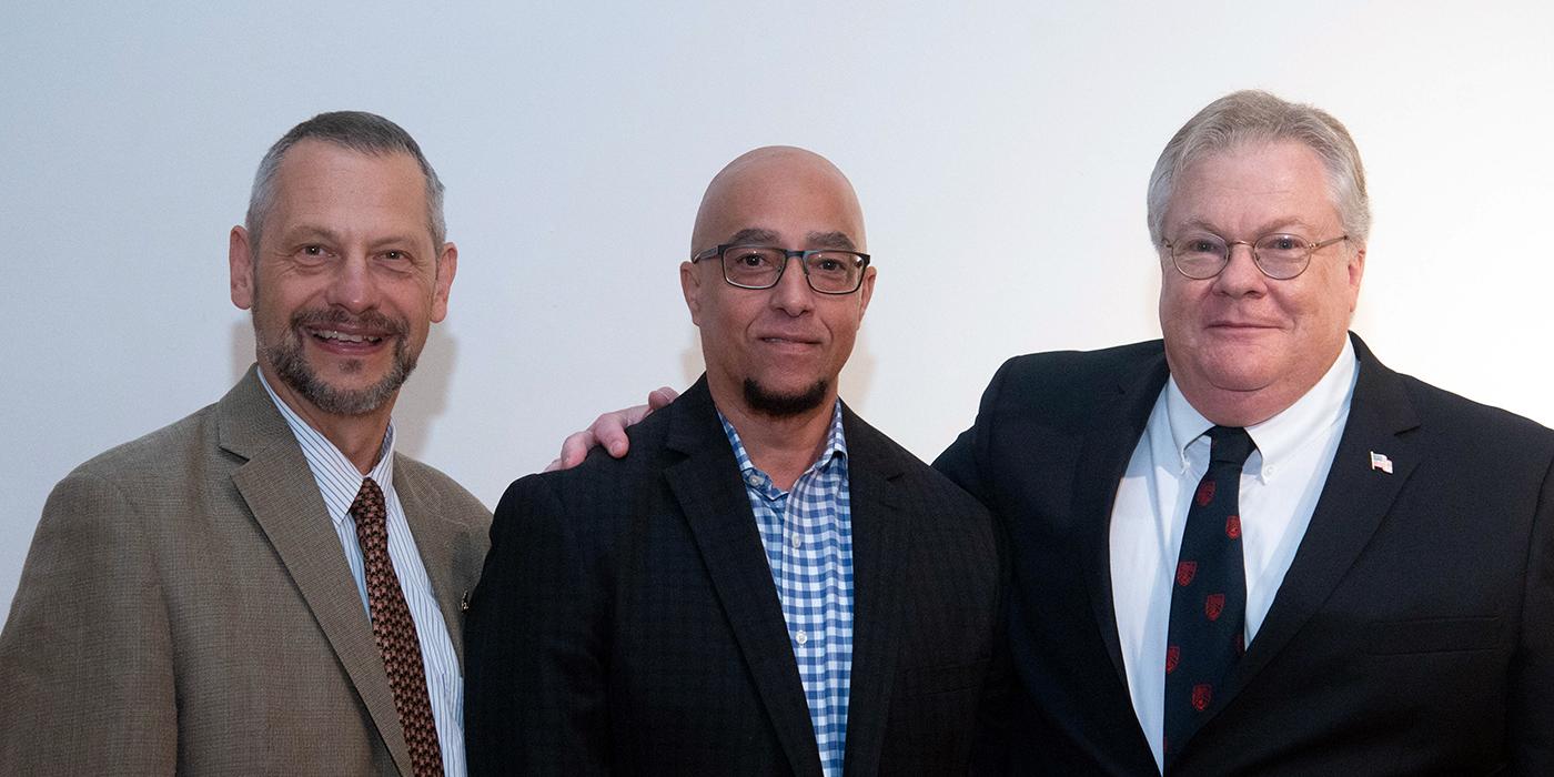 Boris Lushniak, Michael Brown and Brad Hatfield stand shoulder to shoulder smiling