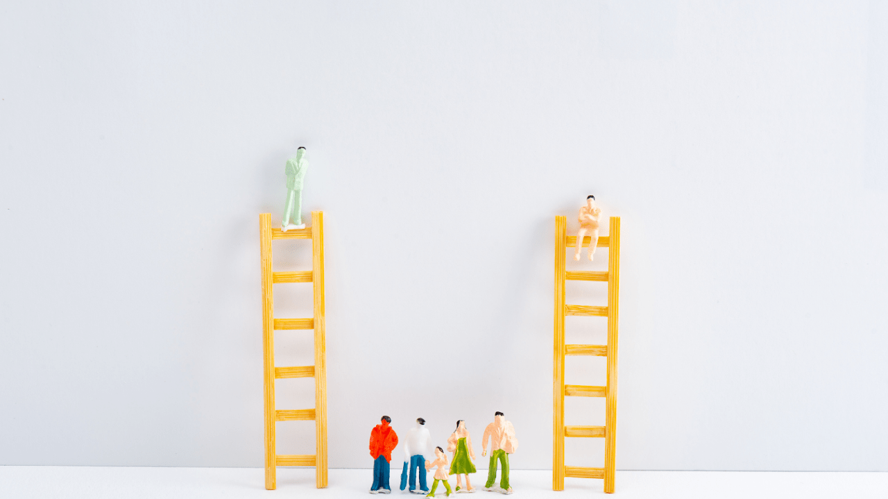 Small plastic human figures on the ground look up at figures on top of ladders