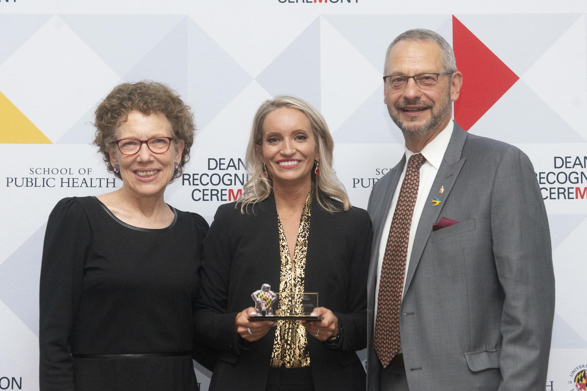 Alyssa Todaro Brooks PhD '15 receives an award from Robin Mockenhaupt and Boris Lushniak