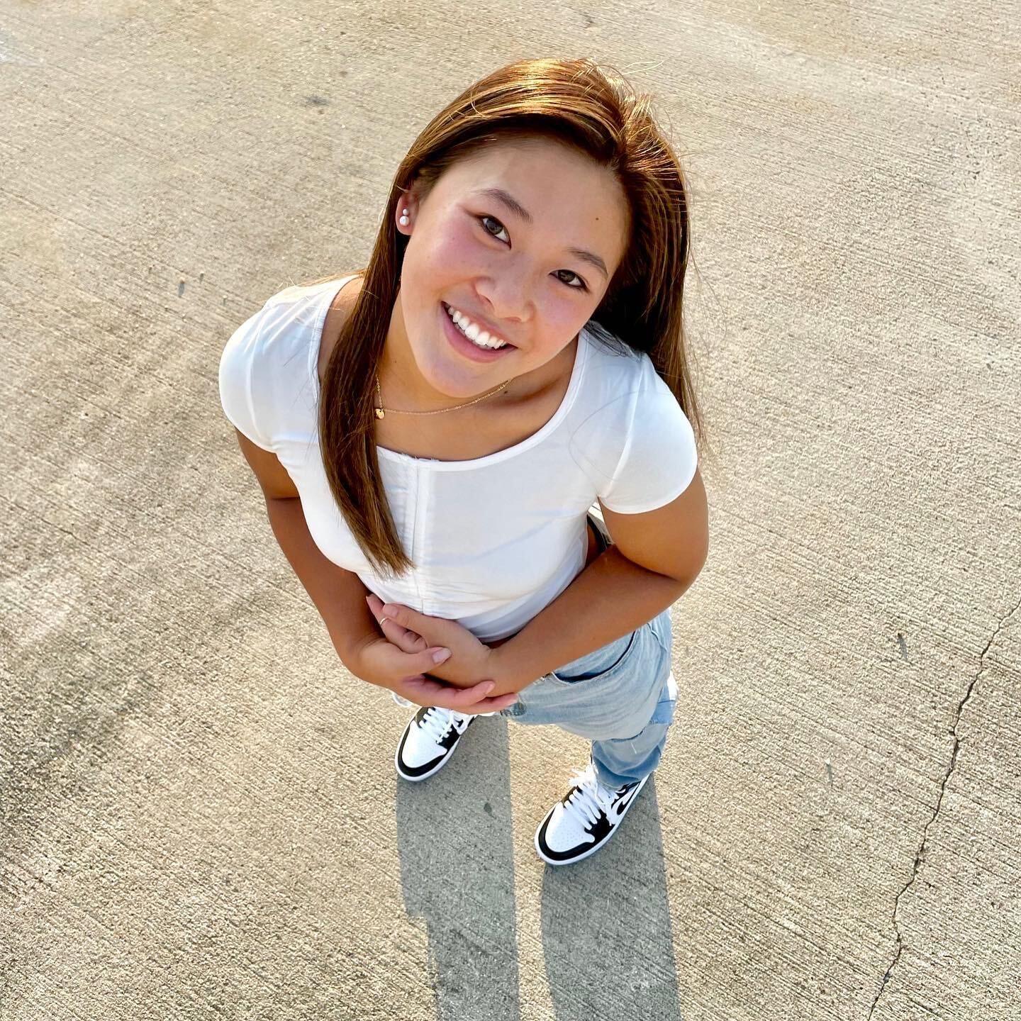 Girl stands looking up at camera