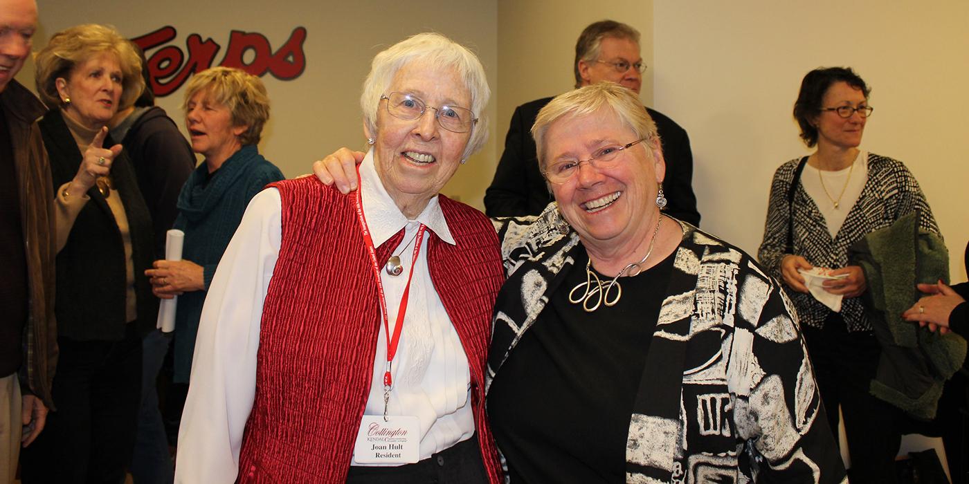 Two white women with short gray hair smiling