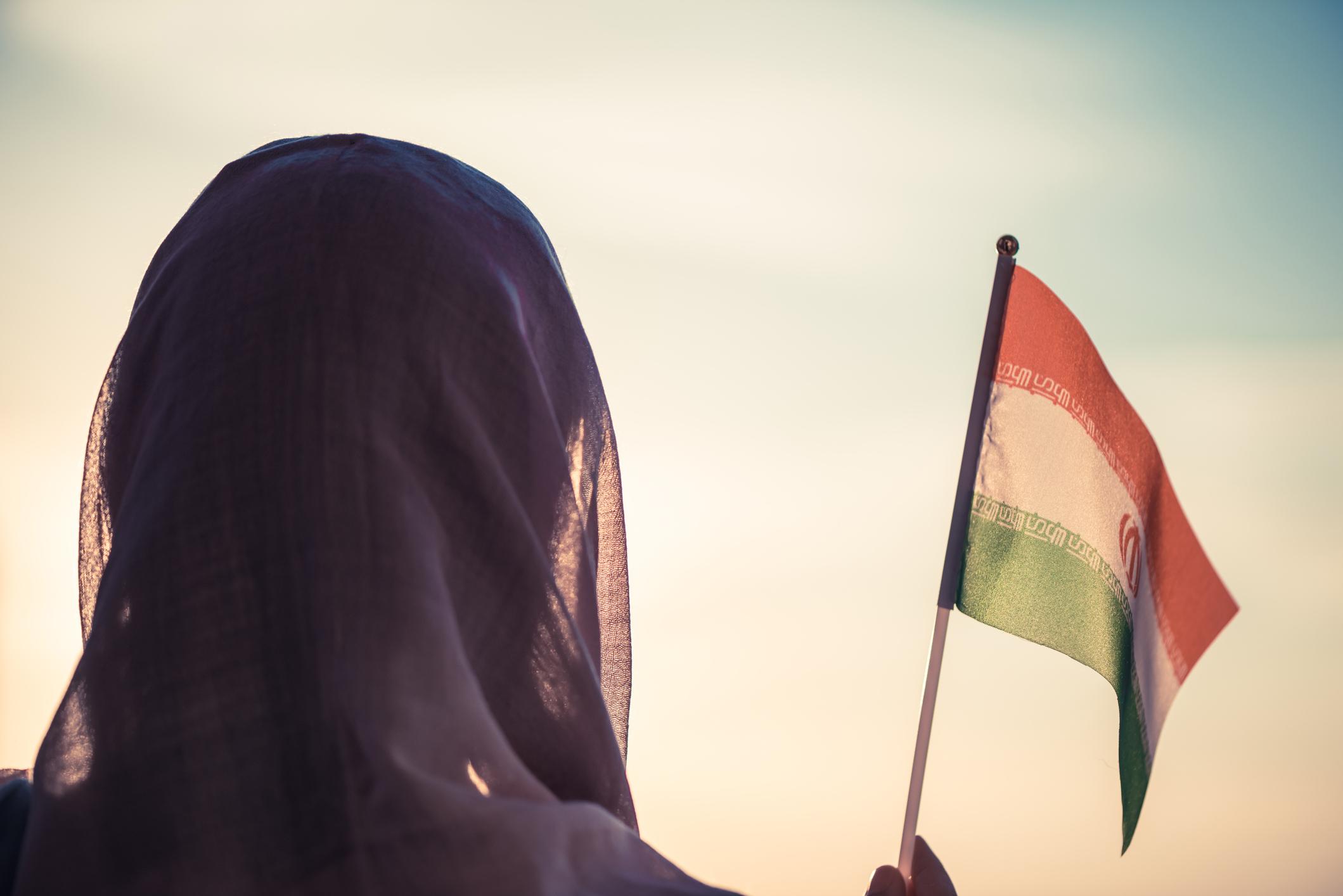 Iranian woman holding an Iranian flag