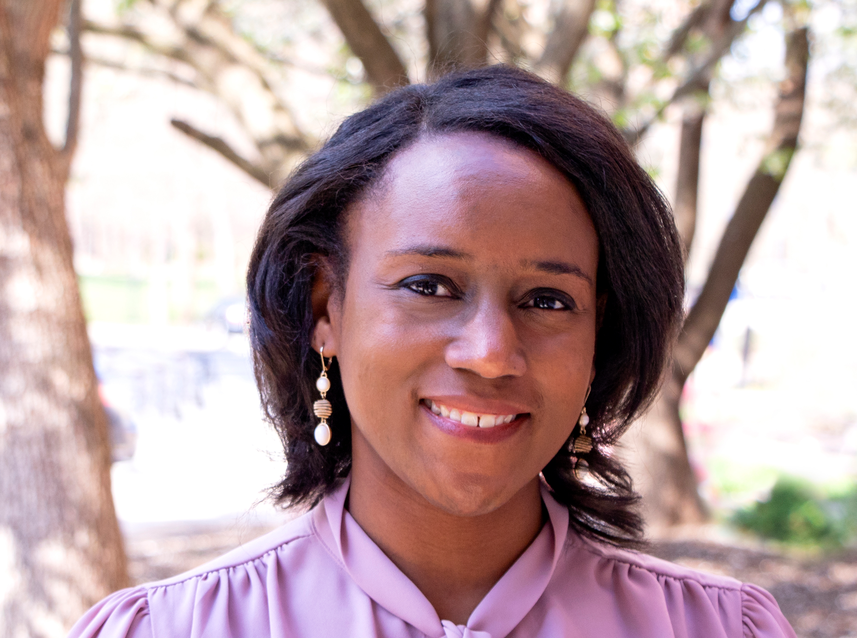 black woman with a purple blouse on