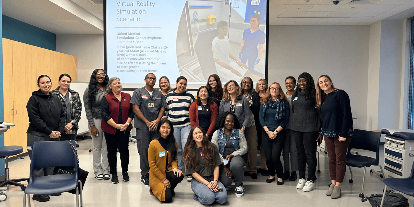 Group photo of students in front of a screen.