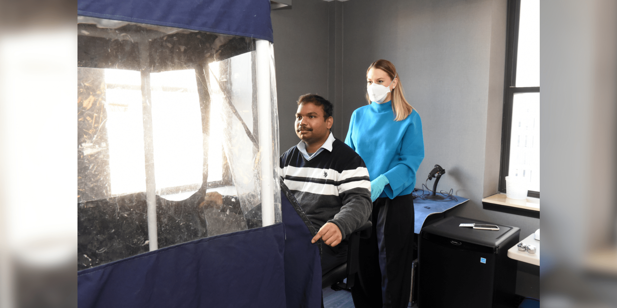 Woman helps man into breathing test