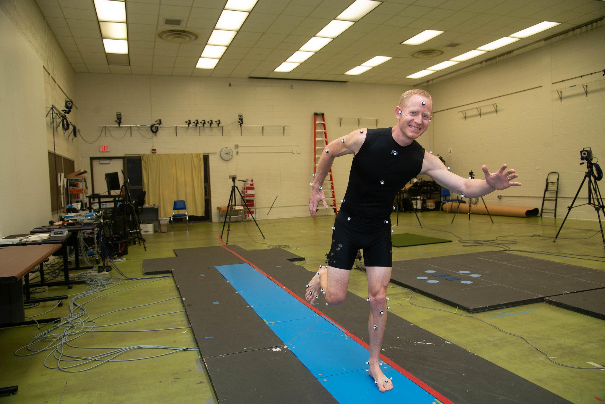 Man poses in running form.