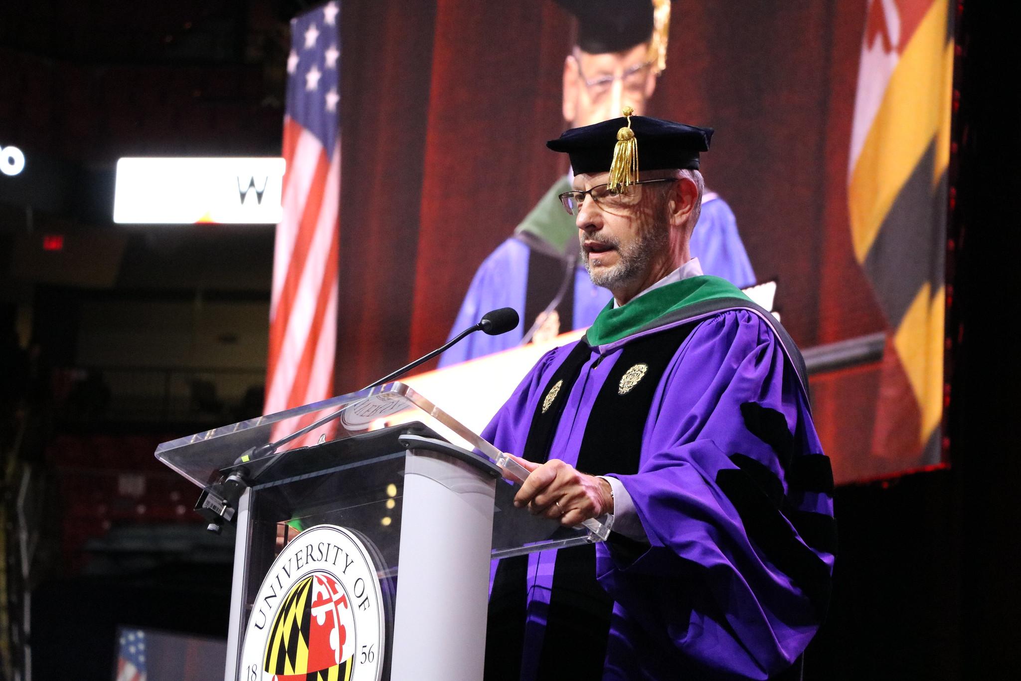 Dean speaking at podium during graduation