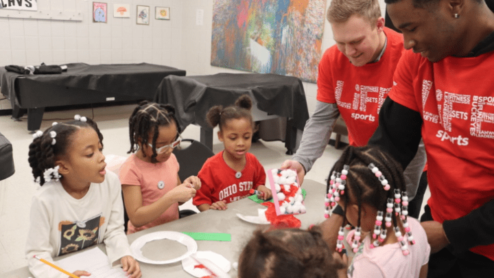 kids and coaches at a table