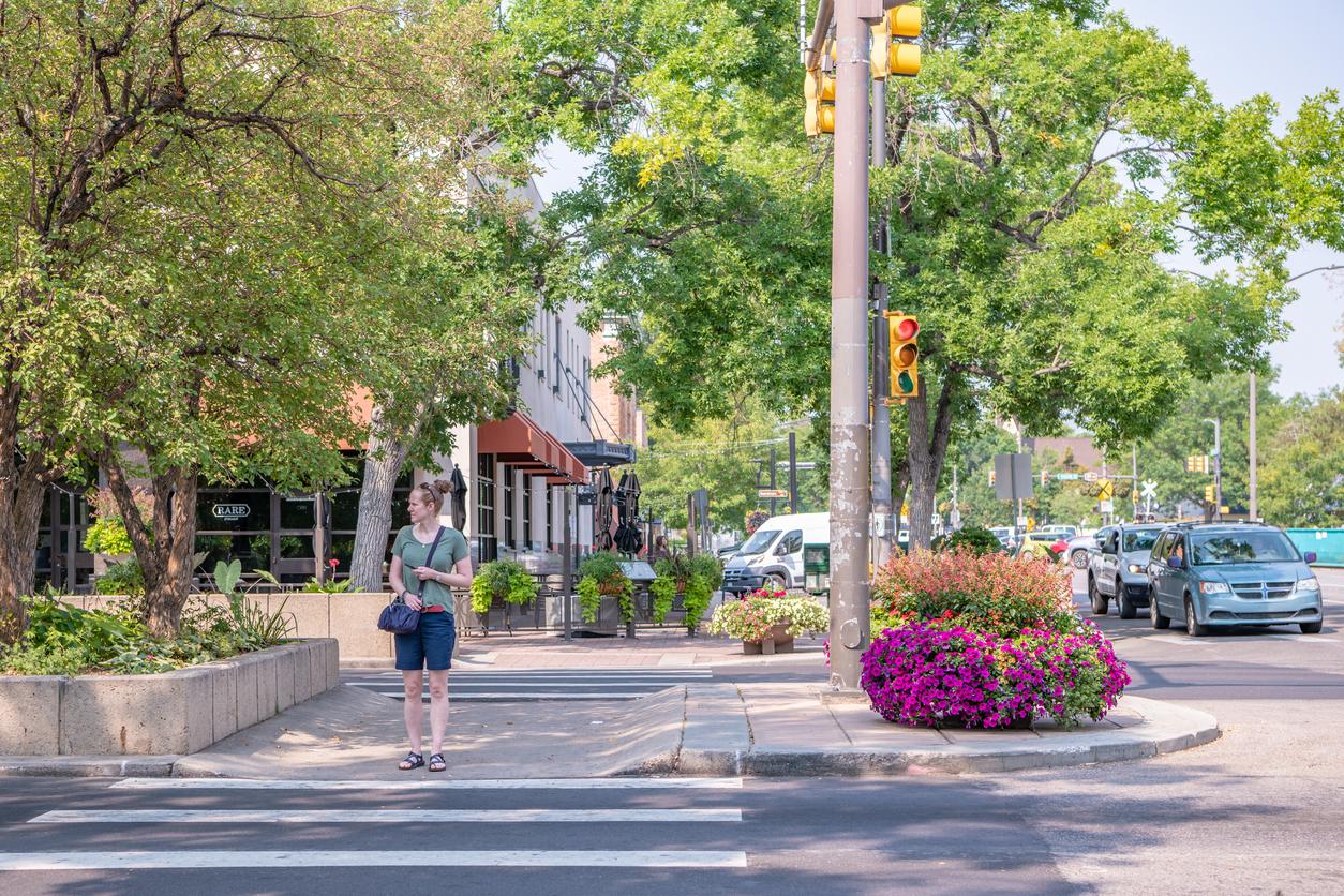 Woman crossing a city street in the crosswalk