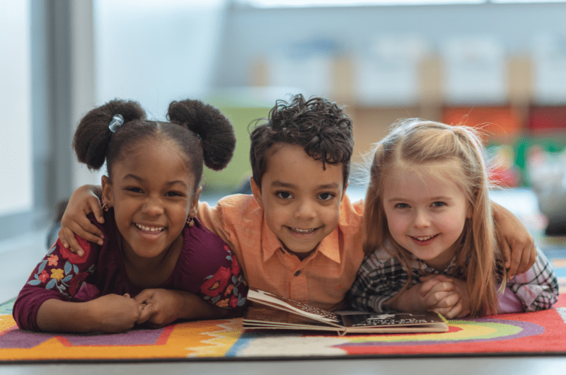 diverse group of kids smiling in a classroom