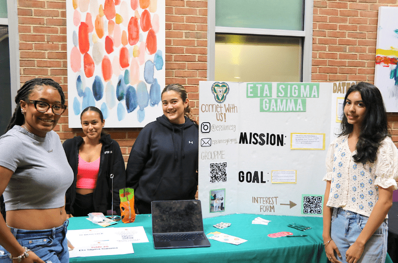 group of students by poster board