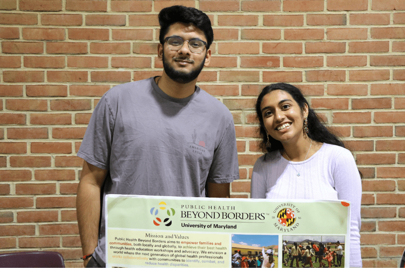 two students at a tabling event